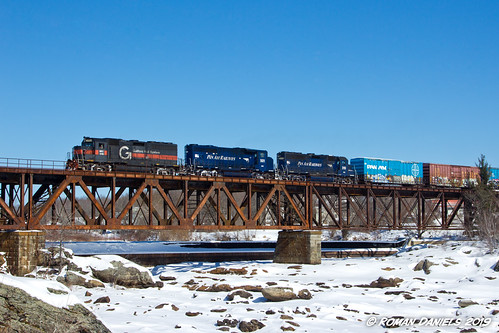 RUPO crossing Great Falls by Roman Daniels, Pan Am Railways train RUPO crosses the Androscoggin River from Lewiston into Auburn on a sunny winte