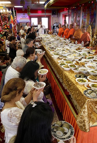 Buddhist monks at the Dhamagosnaram Buddhist Temple in Cranston bless community members who bring them food during Sunday’s New Year celebration. providencejournal.com