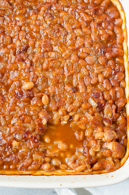Root Beer Baked Beans - the best barbecue side dish! Beans with bacon, root beer, and barbecue sauce are baked until the sauce is thick and delicious. 