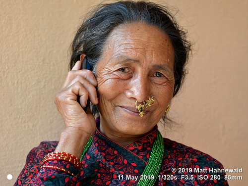 matthahnewaldphotography facingtheworld head face smilingeyes nosepiercing septumpiercing nosejewelry nosering nosestud ear expression cellphone jewelry traditional clothing bodylanguage right hand fun respect travel lifestyle communication prosperity vitality style ethnic tribal local grandmother gorkha nepal asia asian nepali gurung person female elderly old woman women nikond610 nikkorafs85mmf18g 85mm resized 1200x900pixels horizontal street portrait outdoor colour posing authentic phoning calling holding headshot bazaar conceptual 4x3ratio seveneighthsview cultural closeup consensual clarity lookingatcamera closedmouthsmile