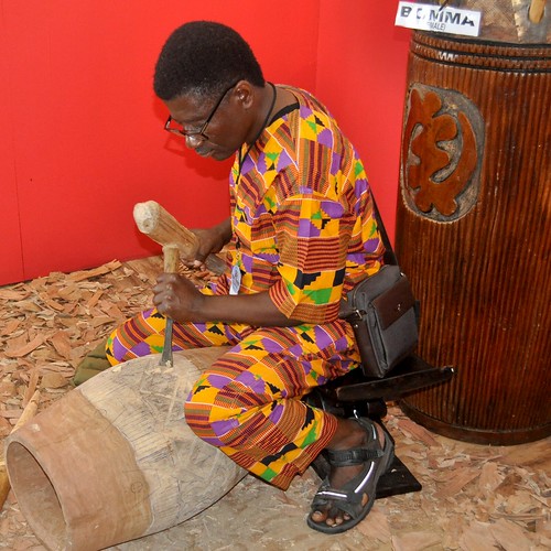 Drum carver James Acheampong of Kumasi, Ghana, at work in the Cultural Exchange Pavilion at  Jazz Fest 2019.