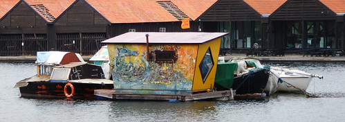 Boats and a floating home/shed in the counter-culture area of Copenhagen called Christiania, Denmark