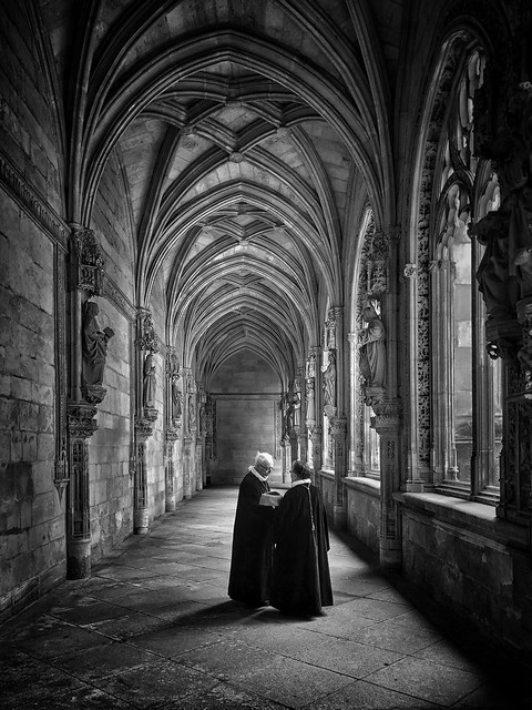 Conversation in the cloisters, Toledo, Spain