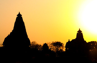 Orange sunset behind Khajuraho temples.  India