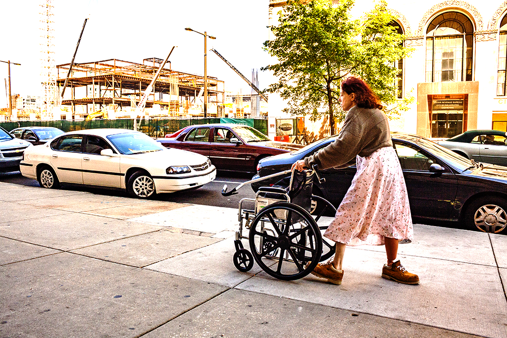 Woman pushing wheelchair--Center City 2