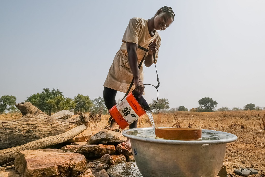 Water collection from a hand dug well near Chiana, Kassena Nankana District - Ghana.