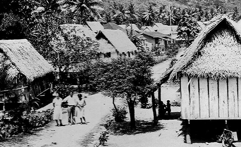 Before the U.S. Naval Era, houses in the villages were commonly constructed of wooden planks with thatched roofs. Similar to this photo of Umatac taken during the Naval Era. Photo from the courtesy of Don Farrell.
