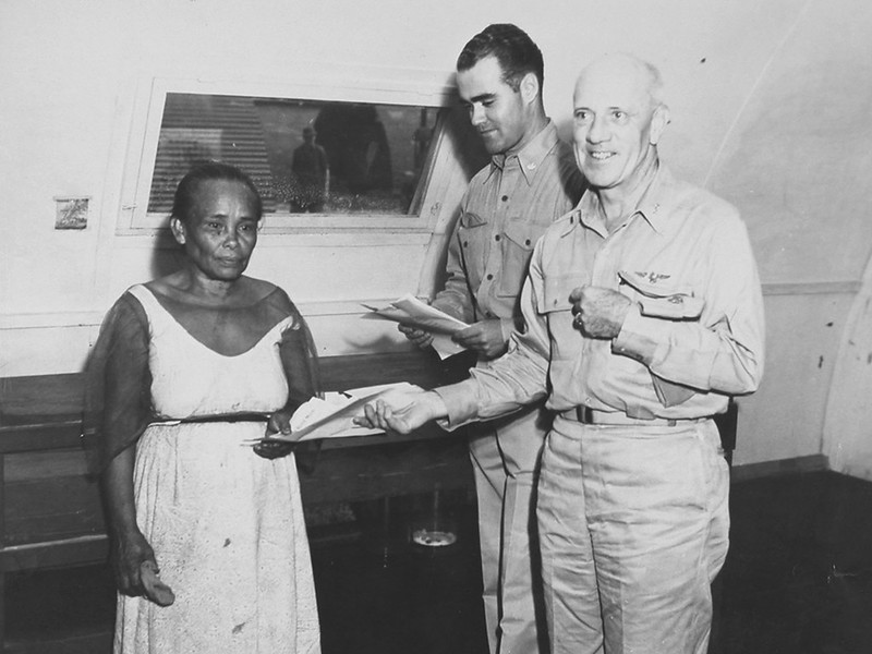 US Naval Governor Charles Pownall (1946-1949) presents a check to an unnamed Chamorro woman for her land taken by the military for bases.

National Archives/Micronesian Seminar