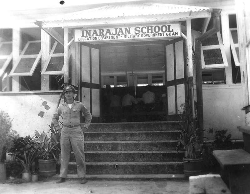 A military man stands outside the Inalåhan/Inarajan School that was established post-WWII. Preservation efforts are underway for this historic structure.

William D. Pesch
