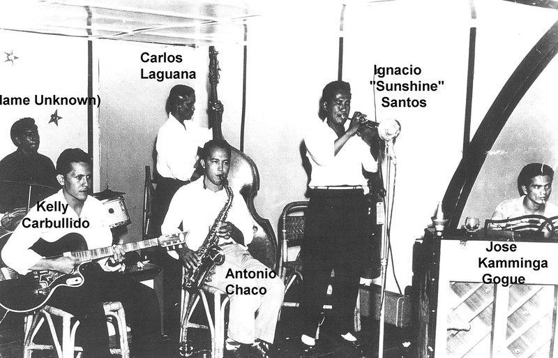 Carlos C. Laguana surrounded by musicians.

Ana Laguana/Guam Humanities Council
