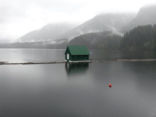 capilano reservoir lake water buoy house mountains mist rain melancholy