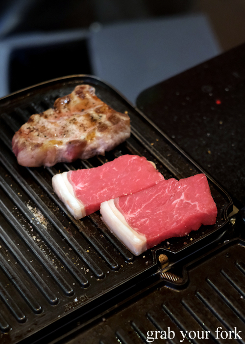 Grilling pork and beef fillet during the omakase sushi menu at Osaka Bar in Darlinghurst Sydney