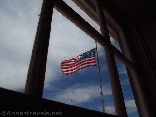 The American flag through the window at the Mount Trumbull Schoolhouse in Grand Canyon-Parashant National Monument, Arizona