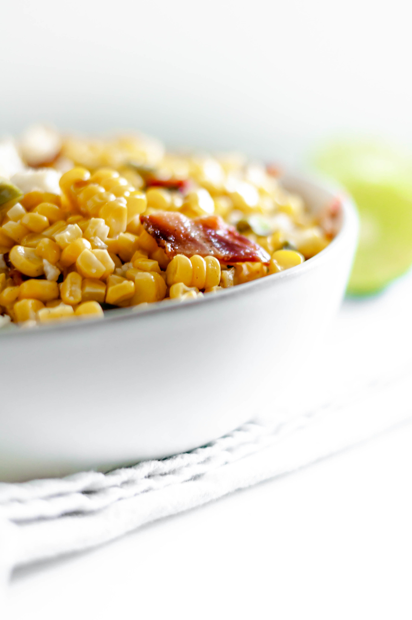 This Grilled Corn Salad with Bacon and Jalapeno is your next potluck dish. Sweet grilled corn, smoky bacon, spicy jalapeno and a bright lime dressing. The perfect addition to any summer barbecue or potluck.