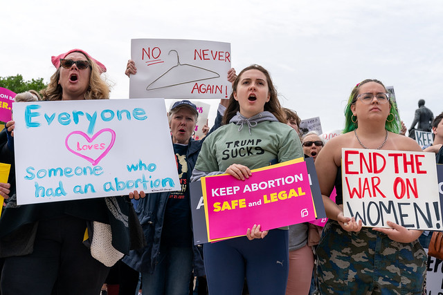 Everyone loves someone who had an abortion and other protests signs sign at a Stop Abortion Bans Rally in St Paul, Minnesota