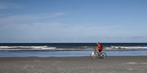 Red beach bicyclist