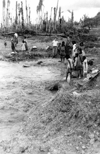 Locals Around Drainage Pipe, 1944