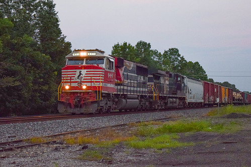 Slow Roll at Ames by Christopher Parma, At twilight on a warm August evening, NS 911 coasts down the main at Ames, TX while traffic clears a