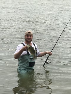 Photo of man holding the smallmouth bass he caught