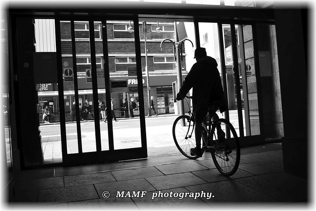 Silhouette cyclist leaving Leeds Kirkgate market..