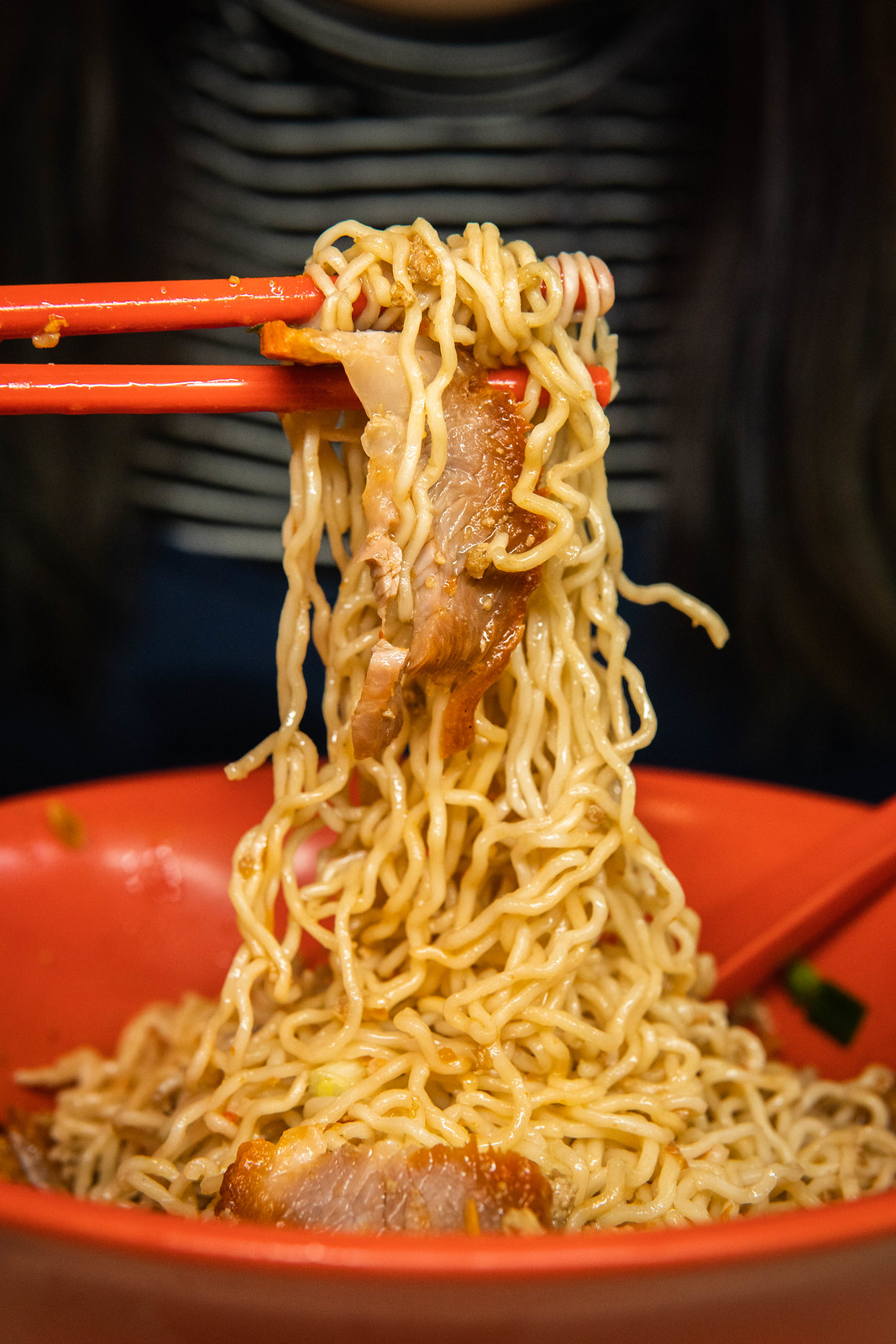 Kolo Mee and Char Siew lifted up by a pair of chopstick