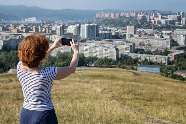 Victoria taking a picture of Krasnoyarsk with her smartphone - Siberia - Russia