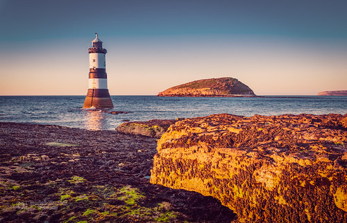 tbnate penmon point penmonpoint wales north northwales anglesey lighthouse seaside sea seascape rocks beach cloudlesssky sky island waves goldenhour nikon nikond750 d750 tamron tamron1530 ultrawideangle ultrawide angle water reflection outdoor outside nature landscape