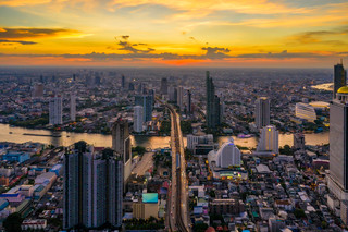 Aerial view of Bangkok skyline and skyscraper with BTS skytrain Bangkok downtown in Thailand at sunset.