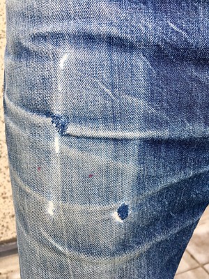 Photo of my jeans pocket with the worn outline of an iPhone SE