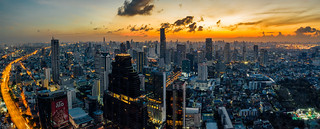 Panorama aerial view of Bangkok skyline and skyscraper with BTS skytrain Bangkok downtown in Thailand at sunrise