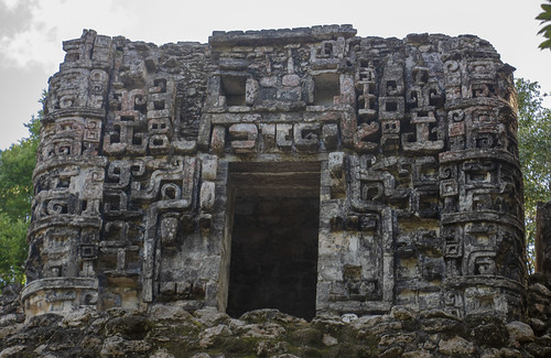 maya art architecture archeology mayan archeological site el hormiguero structure 4 pyramid zoom closeup house chaac masks relief lintel door itzamna ancient rainforest rocks trees bricks clouds rio mouth bec style ruins old reserve calakmul campeche mexico chenes
