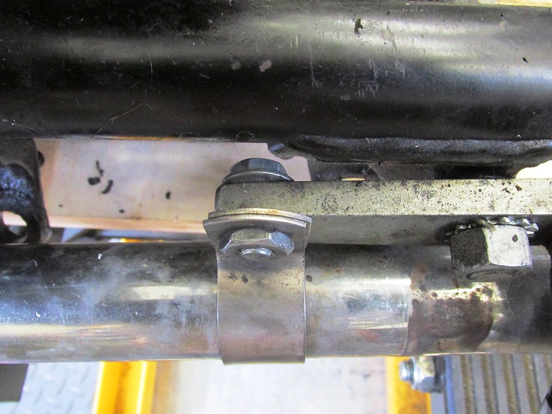 Left Header Pipe Bracket Attached To Front of Brown Side Stand Bracket