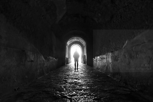 horizontal indoors people one person woman girl silhouette shadow contrast entrance archaeologicalsite roman amphitheatre gate arch tunnel corridor arc architecture unescoworldheritagesite pompeiiarchaeologicalpark parcoarcheologicodipompei light wideangle bugeyeview halo path stone blackandwhite mono monochrome bw travel travelling february 2018 vacation canon 5dmkii camera photography pompeii ancient city campania naples napoli italy europe dark wall