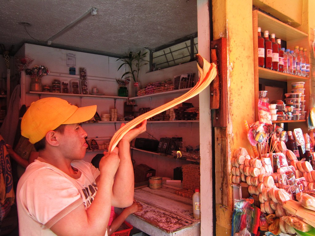 A melcochero hand-pulling melcocho in Baños, Ecuador