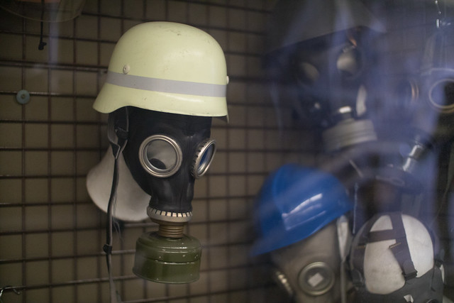 Gas masks and battle helmets in a shop window