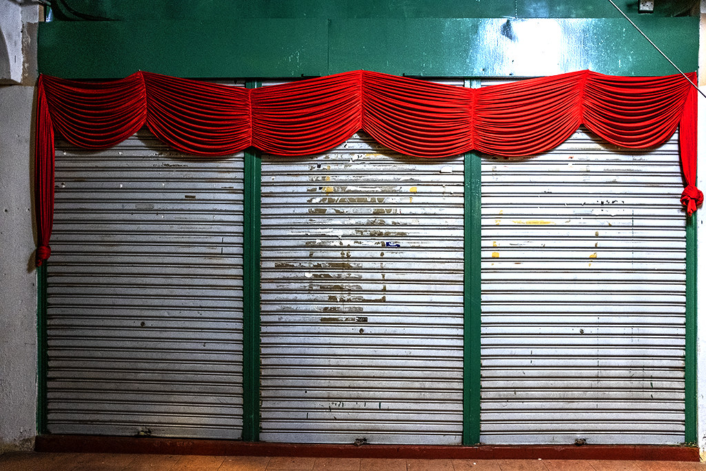 Red curtain above roller doors--Penang