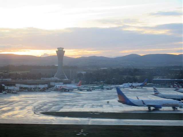 Control tower, mountain view, sunrise takeoff at Edinburgh Airport, Scotland