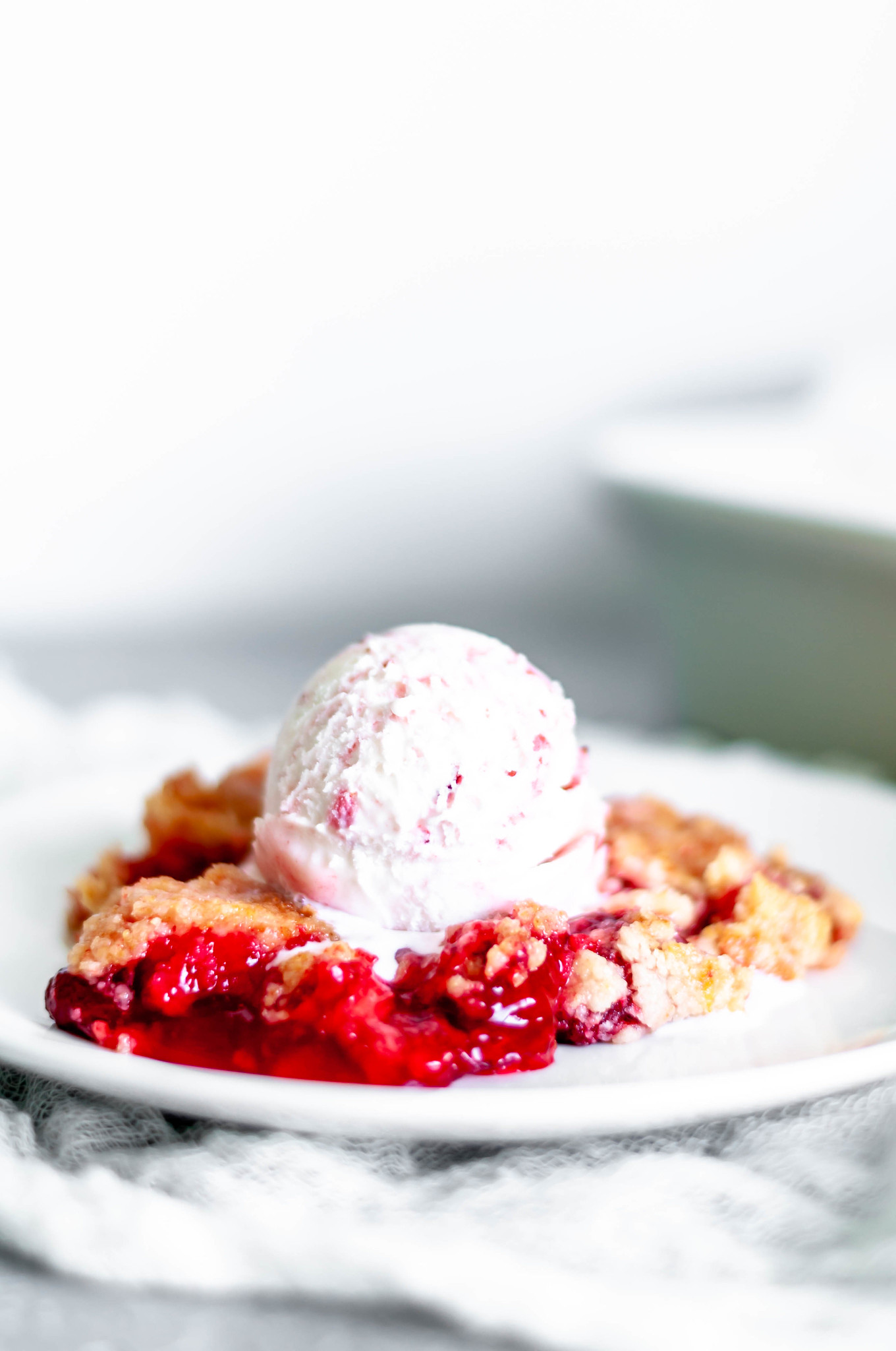 Make this Triple Strawberry Dump Cake for your next party or potluck. Strawberry pie filling, cake mix and ice cream make the ultimate strawberry treat.