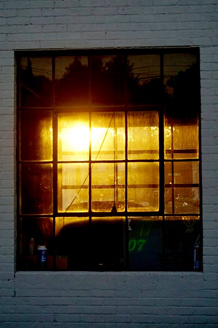 Sunset through the repair shop window. Apex North Carolina Downtown