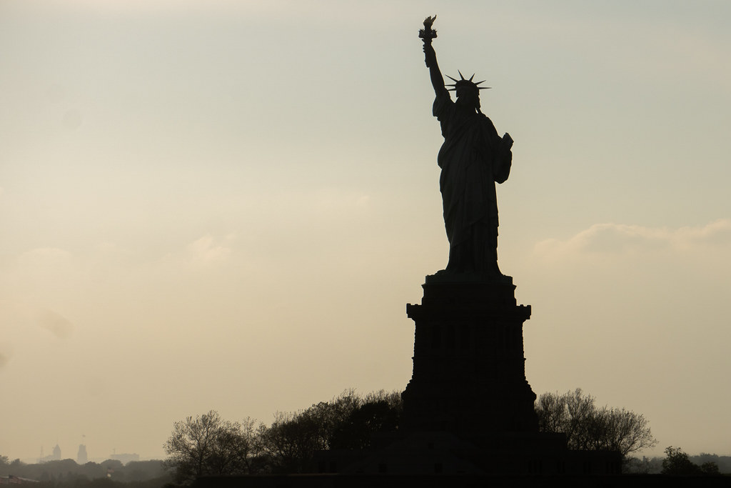 statue of liberty sillhouette at sunset