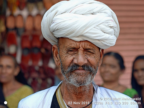 facingtheworld character head face eyes livedinface wrinkles expression moustache stubble white pagari turban respect travel society lifestyle ethnic tribal traditional cultural roadside patriarch family headman grandfather jaipur rajasthan india indian asia asian rajasthani rabari person smallgroup male elderly man photography background nikkorafs85mmf18g 85mm street portrait closeup outdoor colour posing authentic villager oneeye closedeye lookingatcamera clarity fullfaceview headshot nikond610 matthahnewald