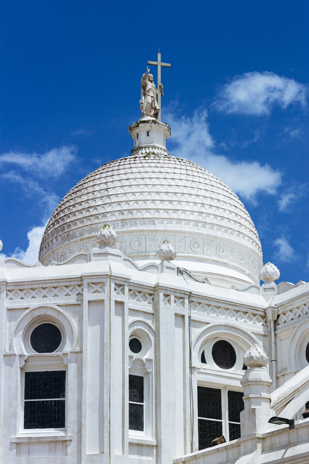 White church building with an onion-shaped dome against a blue sky