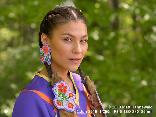 facingtheworld head face eyes expression braids hair feather regalia diversity society lifestyle beauty socialevent powwow equity impact indigenous native traditional cultural festival folklore celebration barrie ontario canada canadian cree firstnation person female young woman women nikkorafs85mmf18g 85mm street portrait closeup threequarterview outdoor naturallight colour posing authentic beautiful pretty dancer bokeh earring lookingatcamera headshot sharpness nikond610 matthahnewald