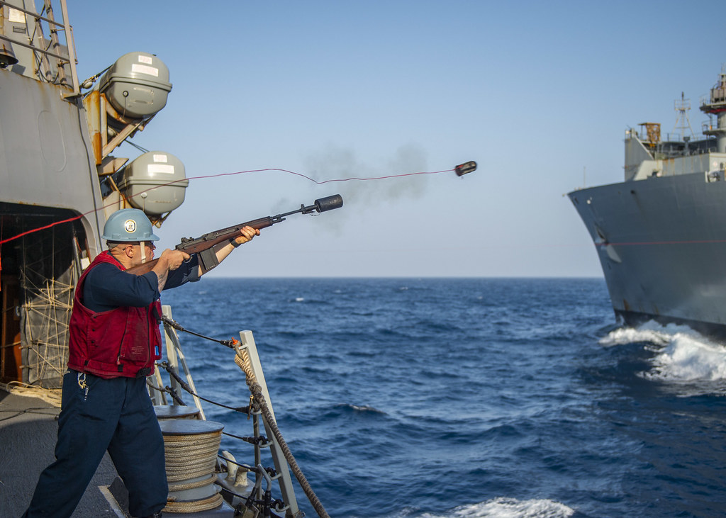 A Sailor fires a shot line to USNS Cesar Chavez (T-AKE 14)… | Flickr