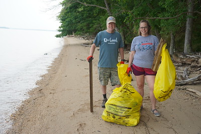Volunteers, father and daughter, collect as much trash as they can along the shorelines of Chippokes.