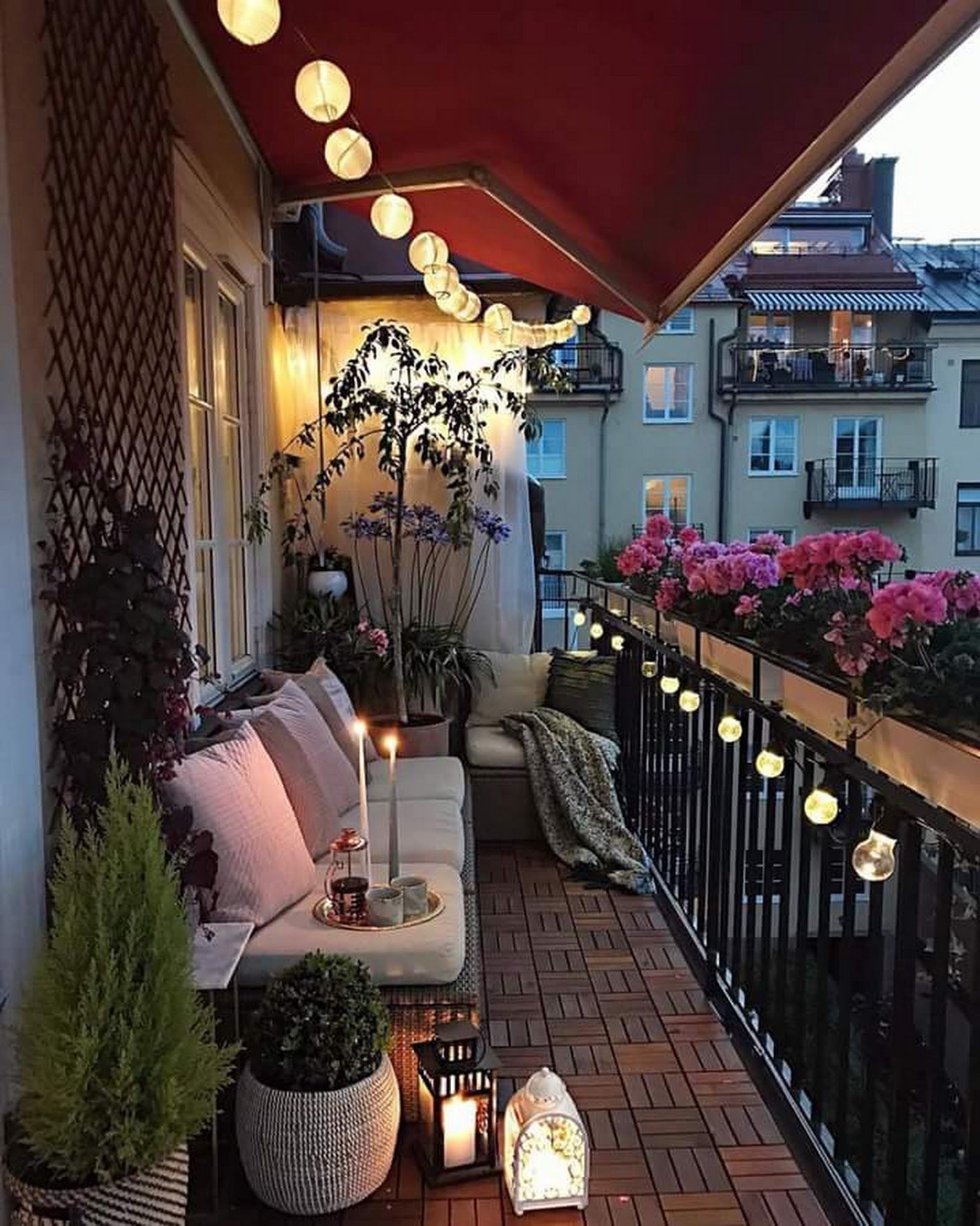 The Best Decorated Small Outdoor Balconies on Pinterest | Small Patio Decor Ideas | Boho Apartment Patio Inspiration | Outdoor Furniture Inspiration | Paper Lantern Lights Railing Flower Pots 
