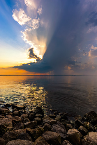 nature clouds sunset storm rain thunderstorm shore rocks water lake wisconsin vertical canoneos5dmarkiii canonef1635mmf4lis