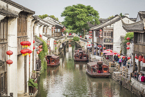 suzhou china shantang canal waterway water boats trees house decoration people tourists busy shops street candid