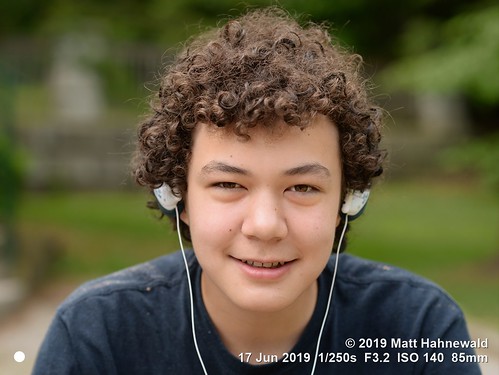 matthahnewaldphotography facingtheworld head face eyes expression hair curlyhair curls curly earphones relationship parentalconsent diversity lifestyle communication upbringing education childhood optimism photoshoot grandson barrie ontario canada canadian ontarian mixedrace person male child boy preteen nikond610 nikkorafs85mmf18g 85mm street portrait closeup headshot fullfaceview outdoor naturallight colour posingcamera smiling handsome multiracial visibleminority family puberty conceptual cultural oriental lookingatcamera