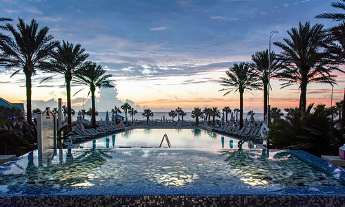 ameliaisland fernandinabeach pool omniresort sunset water sky clouds poollights lights palmtrees hotelpool resortpool poolchairs